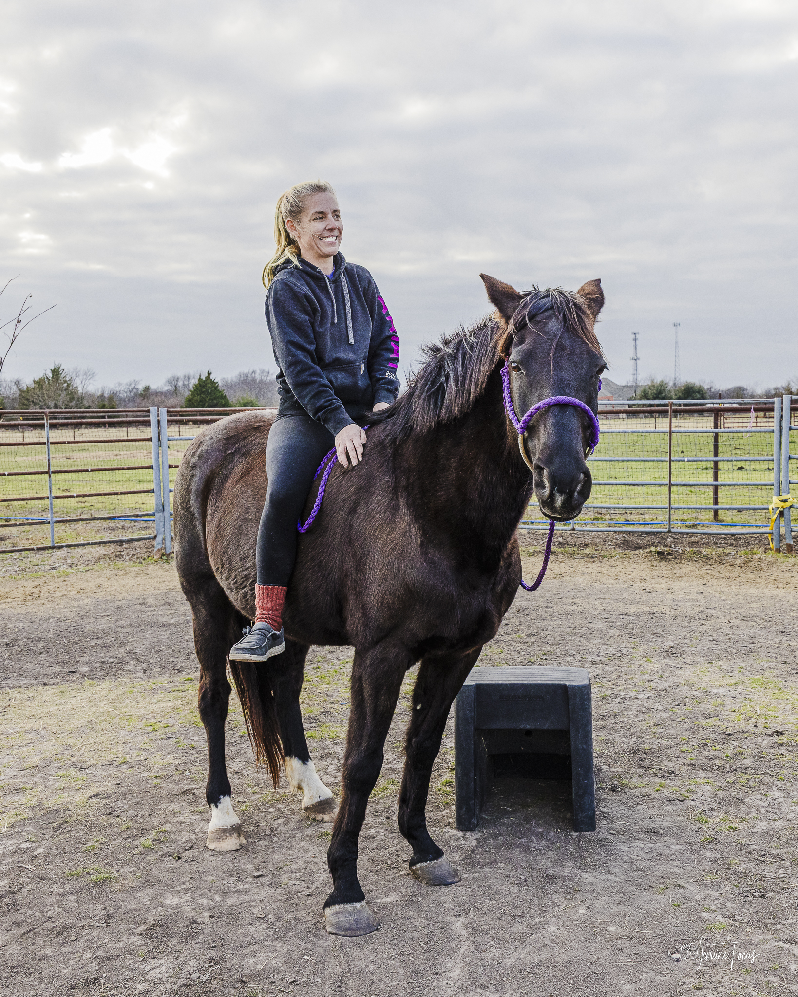 A woman riding a horse outdoors at Hidden Pastures